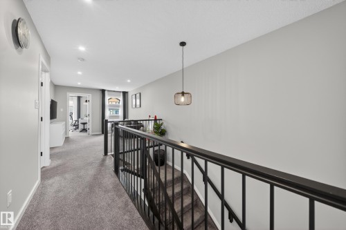 Carpeted hallway with recessed lighting and a contemporary pendant fixture - 3337 Kulay Way, Edmonton, AB - Indoor Photo Showing Other Room