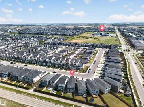 Expansive residential development featuring numerous contemporary homes with dark-pitched roofs - 3337 Kulay Way, Edmonton, AB - Outdoor With View