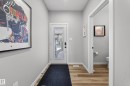 Entryway featuring wood-finish flooring and a white paneled door with a frosted glass insert - 3337 Kulay Way, Edmonton, AB  - Indoor Photo Showing Other Room 