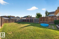 Expansive grassy yard with full privacy fencing - 