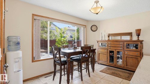 Dining area featuring a large window, neutral wall paint, and tile flooring - 4309 37A Avenue, Edmonton, AB - Indoor Photo Showing Dining Room