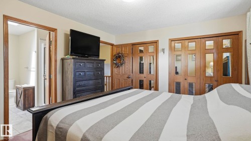 Bedroom featuring warm neutral wall tones and carpet flooring - 4309 37A Avenue, Edmonton, AB - Indoor Photo Showing Bedroom
