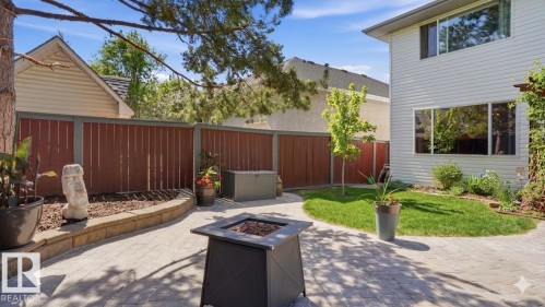 Backyard patio featuring extensive paver stone hardscaping, a defined lawn area, and mature landscaping - 4309 37A Avenue, Edmonton, AB - Outdoor