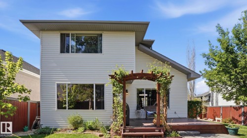 Rear exterior featuring white horizontal siding and a multi-level wood deck - 4309 37A Avenue, Edmonton, AB - Outdoor