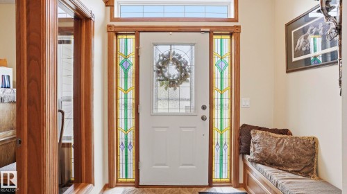 Entryway featuring a white paneled door with a decorative glass insert, flanked by stained glass sidelights, and topped with a transom window - 4309 37A Avenue, Edmonton, AB - Indoor Photo Showing Other Room