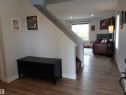 Entryway featuring wood-finish flooring, white paneled doors, and light gray walls - 17348 8 Avenue, Edmonton, AB  - Indoor Photo Showing Other Room 