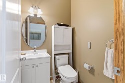 Bathroom with white vanity, integrated sink, and chrome faucet - 