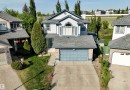 Two-story residence featuring light siding and a prominent arched window on the upper level - 442 Hunters Green, Edmonton, AB  - Outdoor 