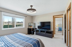 Bright bedroom featuring neutral wall tones and light-colored carpet - 