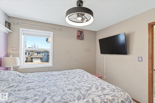 Recessed window with white trim, a modern ceiling fan with integrated lighting, and neutral wall paint - 442 Hunters Green, Edmonton, AB - Indoor Photo Showing Bedroom