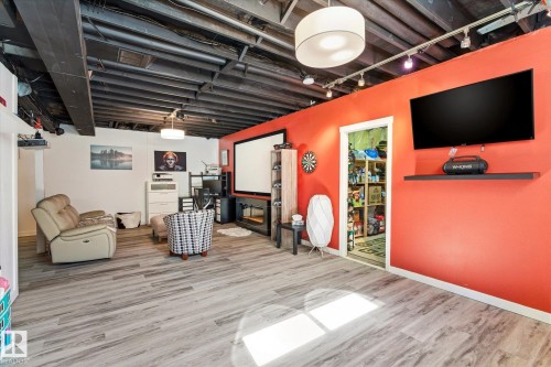 Finished lower level featuring wood-finish flooring and a painted open-joist ceiling - 442 Hunters Green, Edmonton, AB - Indoor
