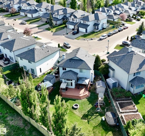 Expansive rear yard featuring a multi-level wood deck, fire pit area, and mature trees - 442 Hunters Green, Edmonton, AB - Outdoor With View