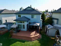Expansive rear deck featuring multiple levels and a built-in hot tub - 