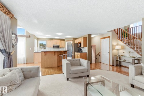 Bright living area featuring a vaulted ceiling and a large window - 442 Hunters Green, Edmonton, AB - Indoor Photo Showing Living Room