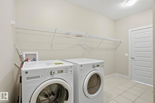 Dedicated laundry area featuring tile flooring and neutral wall tones - 1915 77 Street, Edmonton, AB - Indoor Photo Showing Laundry Room
