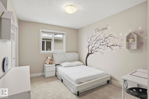 Bright room featuring neutral wall paint, a single window with white trim, and a ceiling-mounted light fixture - 1915 77 Street, Edmonton, AB - Indoor Photo Showing Bedroom