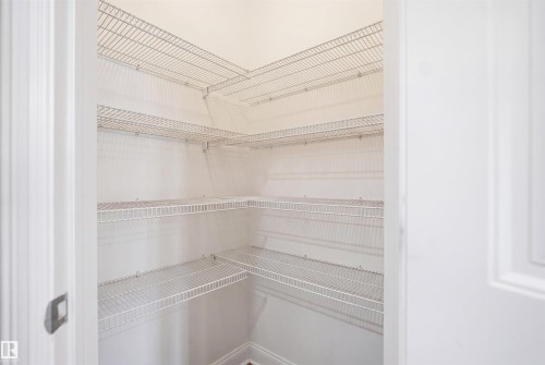 Walk-in pantry featuring multiple levels of wire shelving and bright white walls - 1523 36 Avenue, Edmonton, AB - Indoor With Storage