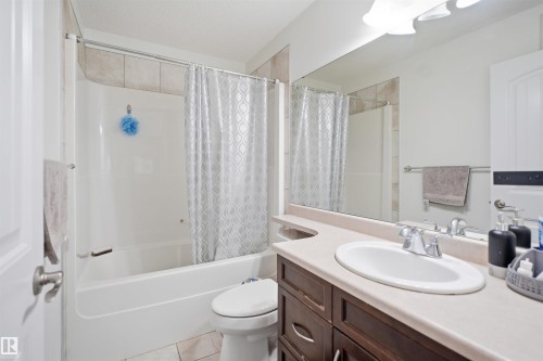Bathroom featuring a white tub and shower combination with tile surround - 1523 36 Avenue, Edmonton, AB - Indoor Photo Showing Bathroom