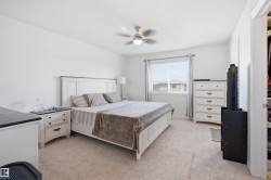 Spacious room featuring neutral carpeting and a ceiling fan with integrated lighting - 