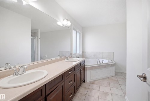 Bathroom featuring a double vanity with dark wood-finish cabinetry and light countertops - 1523 36 Avenue, Edmonton, AB - Indoor Photo Showing Bathroom