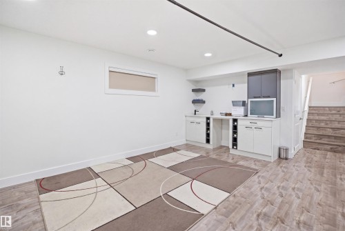 Open concept room with wood-finish flooring, recessed lighting, and a horizontal window - 1523 36 Avenue, Edmonton, AB - Indoor Photo Showing Other Room