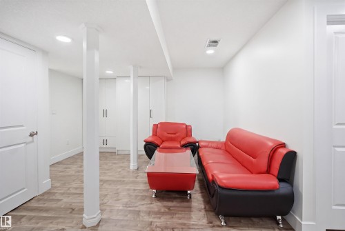 Finished room featuring wood-finish flooring, white walls, and recessed lighting - 1523 36 Avenue, Edmonton, AB - Indoor