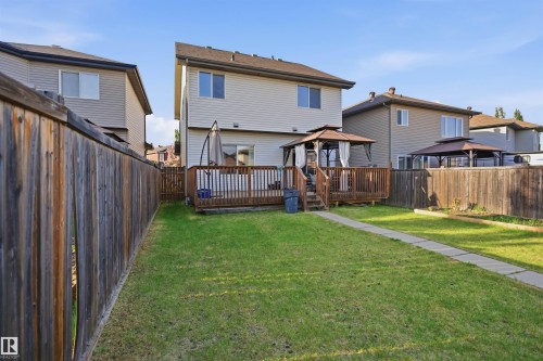 Rear exterior featuring a two-story home with light-colored siding and a brown roof - 1523 36 Avenue, Edmonton, AB - Outdoor With Deck Patio Veranda