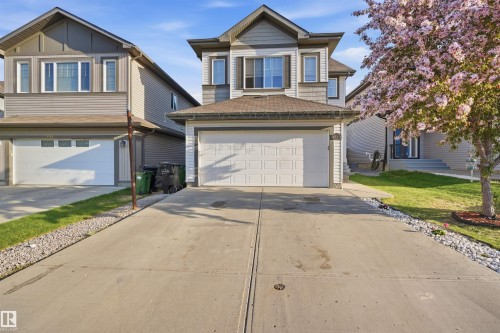 Contemporary two-story residence featuring a front-facing attached garage, concrete driveway, and a gabled roofline - 1523 36 Avenue, Edmonton, AB - Outdoor With Facade