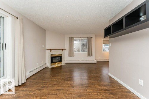 203 8503 108 Street, Edmonton, AB - Indoor Photo Showing Living Room With Fireplace