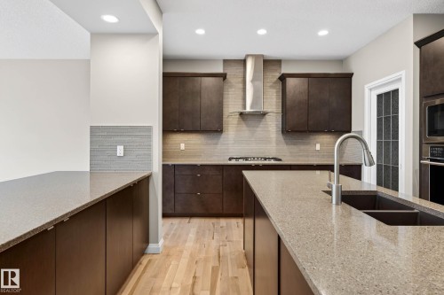 Kitchen featuring an expansive island with a double basin sink and gooseneck faucet - 17838 60A Street, Edmonton, AB - Indoor Photo Showing Kitchen With Double Sink With Upgraded Kitchen