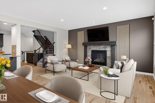 Living area featuring a floor-to-ceiling fireplace with a tile surround and wood mantel - 17838 60A Street, Edmonton, AB - Indoor Photo Showing Living Room With Fireplace