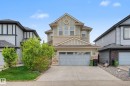 Two-story residence featuring light green siding and stone accents - 17838 60A Street, Edmonton, AB  - Outdoor 