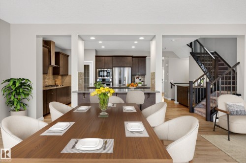 Open-concept dining area featuring wood-finish flooring, recessed lighting, and access to the kitchen - 17838 60A Street, Edmonton, AB - Indoor Photo Showing Other Room