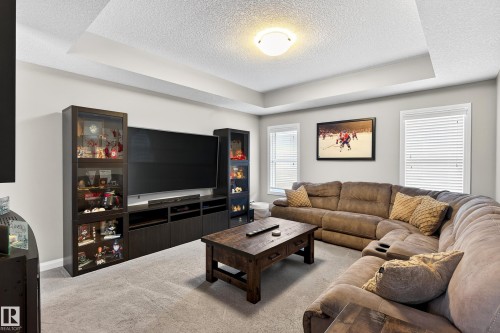 Spacious living area featuring a tray ceiling, recessed lighting, and light gray wall paint - 17838 60A Street, Edmonton, AB - Indoor Photo Showing Living Room