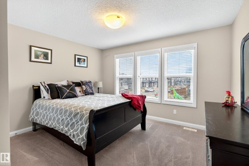 Bedroom featuring neutral wall paint, textured ceiling, and carpeted flooring - 17838 60A Street, Edmonton, AB - Indoor Photo Showing Bedroom