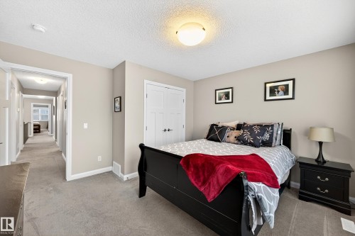 Carpeted bedroom with neutral wall tones and a ceiling-mounted light fixture - 17838 60A Street, Edmonton, AB - Indoor Photo Showing Bedroom