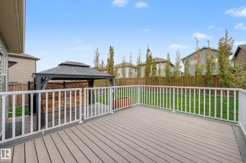Spacious backyard featuring a composite deck with white railings, a detached gazebo, a stone patio, and a privacy fence - 17838 60A Street, Edmonton, AB - Outdoor With Deck Patio Veranda With Exterior