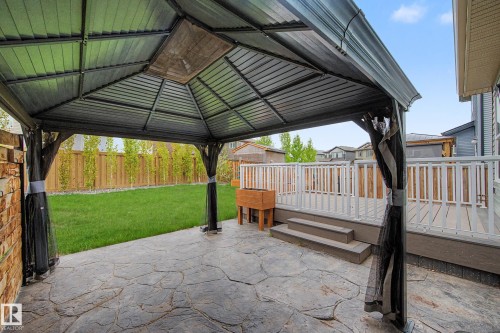 Covered stamped concrete patio with a detached gazebo featuring a metal roof - 17838 60A Street, Edmonton, AB - Outdoor With Deck Patio Veranda With Exterior