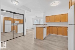 Open-concept living space featuring wood-finish flooring throughout - 