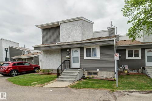 Multi-level exterior featuring horizontal siding and white brick accents - 5626 19A Avenue, Edmonton, AB 