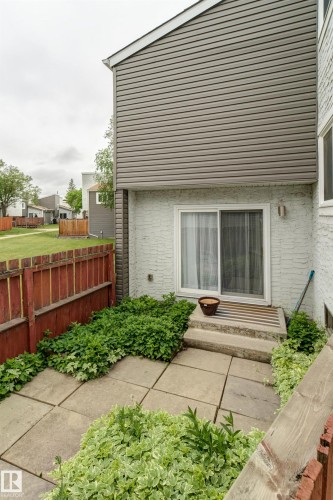 Private patio area featuring concrete paver flooring and surrounding greenery - 5626 19A Avenue, Edmonton, AB 