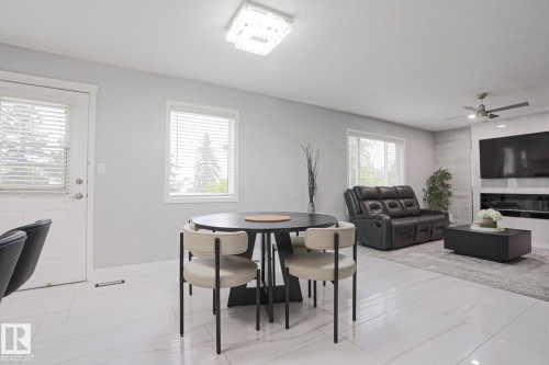 Open-concept living area featuring large format tile flooring and a modern ceiling fan - 313 Jillings Crescent, Edmonton, AB - Indoor