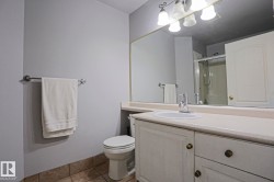 Bathroom vanity with an integrated sink, polished chrome faucet, and expansive wall-mounted mirror - 