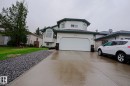 White siding residence featuring a two-car garage, concrete driveway, and a gravel landscaping strip - 313 Jillings Crescent, Edmonton, AB  - Outdoor With Facade 
