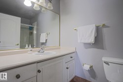 Bathroom vanity featuring a white oval sink, chrome faucet, and ample countertop space - 