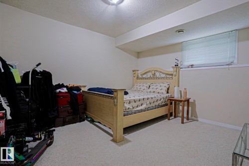 Carpeted room with a window featuring horizontal blinds - 313 Jillings Crescent, Edmonton, AB - Indoor Photo Showing Bedroom