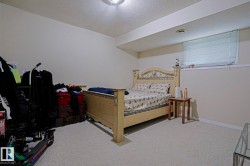 Carpeted room with a window featuring horizontal blinds - 