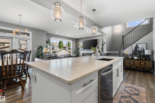 Central kitchen island with an undermount sink and integrated dishwasher - 524 Mcdonough Way, Edmonton, AB - Indoor