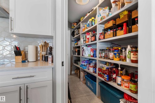 Walk-in pantry featuring extensive built-in shelving, providing abundant storage - 524 Mcdonough Way, Edmonton, AB - Indoor