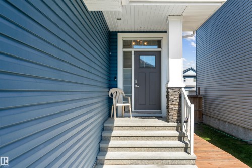 Entryway featuring a dark gray door with square glass pane, sidelight, and transom window - 524 Mcdonough Way, Edmonton, AB - Outdoor
